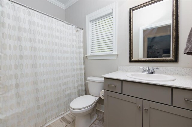 bathroom with crown molding, tile patterned floors, vanity, and toilet