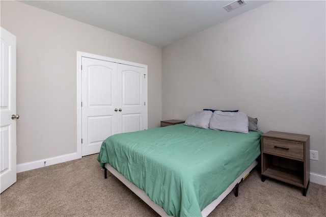 carpeted bedroom featuring a closet