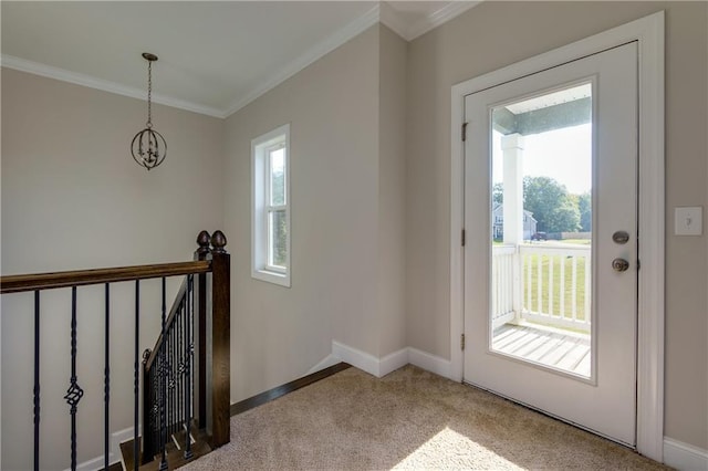 doorway to outside featuring ornamental molding, light colored carpet, and a wealth of natural light