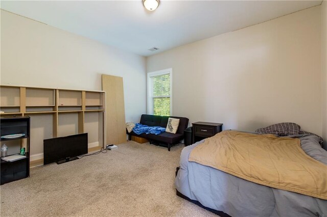 bedroom featuring light carpet