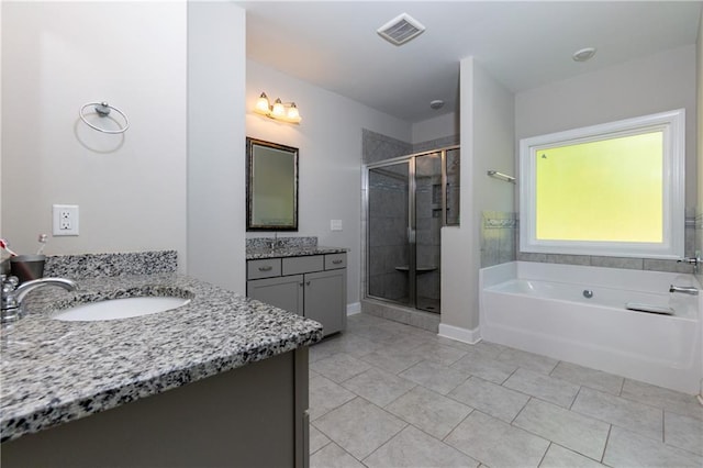 bathroom featuring vanity, shower with separate bathtub, and tile patterned floors