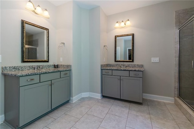 bathroom featuring tile patterned floors, vanity, and an enclosed shower