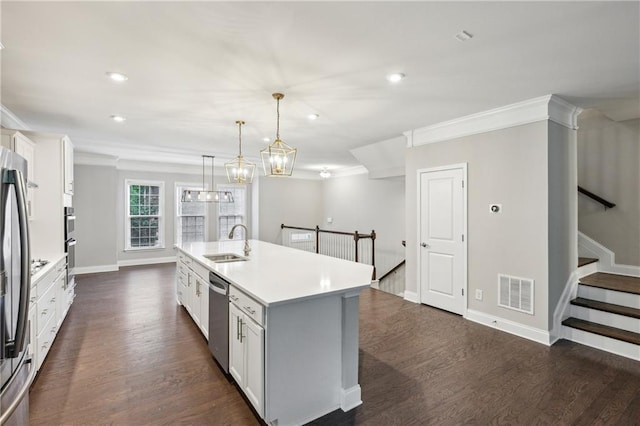 1036 Grant Park Rd, Decatur, GA 30033 - kitchen featuring a sink, ornamental molding, dark wood-type flooring, appliances with stainless steel finishes, and a kitchen island with sink