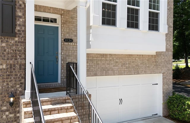 1036 Grant Park Rd, Decatur, GA 30033 - property entrance featuring brick siding, an attached garage, and driveway