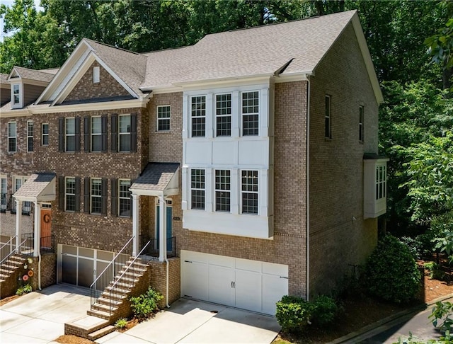 1036 Grant Park Rd, Decatur, GA 30033 - view of front of home with a garage, concrete driveway, and brick siding