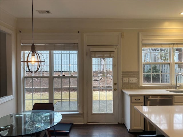 entryway with sink, dark hardwood / wood-style floors, and crown molding