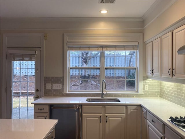 kitchen featuring white cabinets, backsplash, dishwasher, and sink