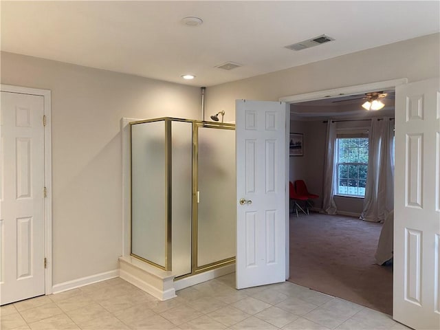 bathroom with ceiling fan and a shower with shower door