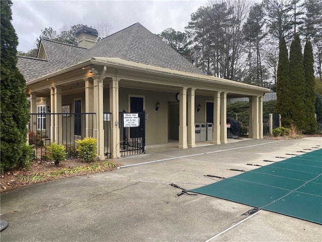 exterior space featuring a community pool and a patio