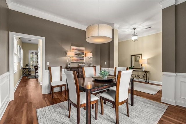 dining space featuring dark hardwood / wood-style flooring and ornamental molding