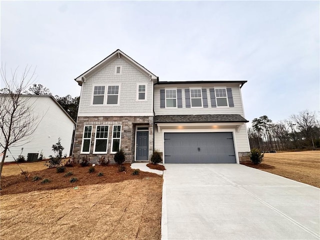 craftsman house featuring stone siding, driveway, an attached garage, and central AC unit