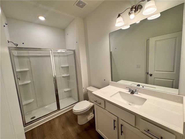 full bath with toilet, a shower stall, visible vents, and wood finished floors