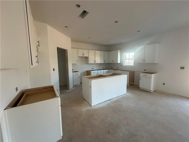 kitchen featuring white cabinets and a center island