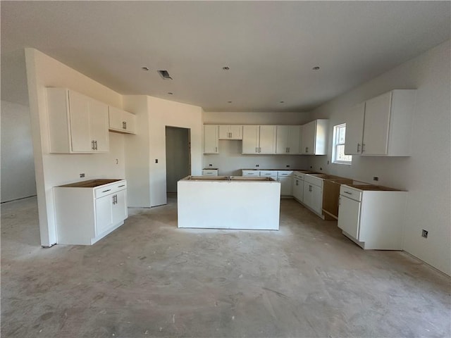 kitchen featuring white cabinets and a center island