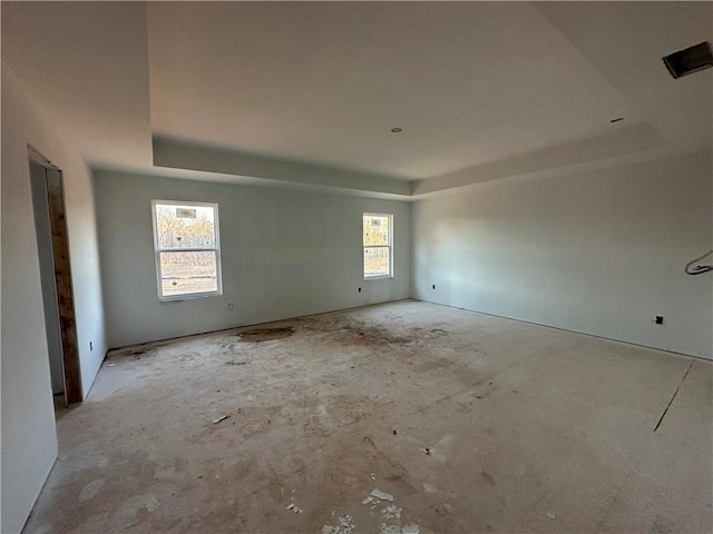 unfurnished room featuring a tray ceiling