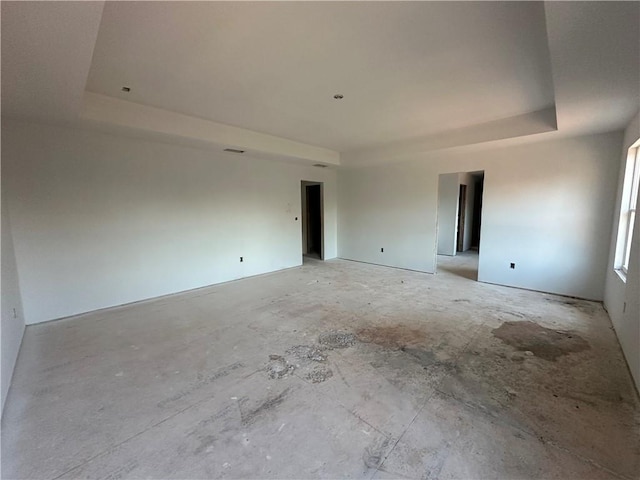 empty room with a raised ceiling