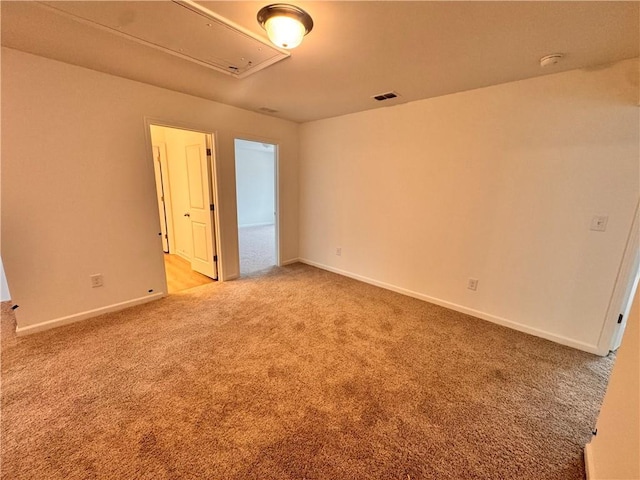 unfurnished bedroom featuring light carpet, visible vents, and baseboards