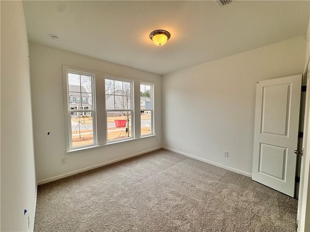 spare room with carpet flooring and baseboards