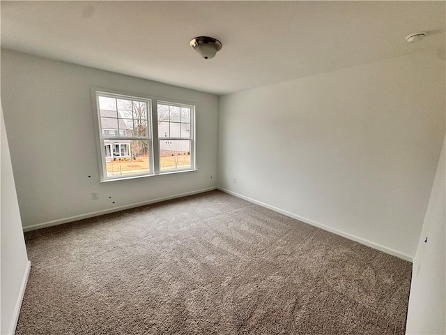 spare room with carpet floors and baseboards