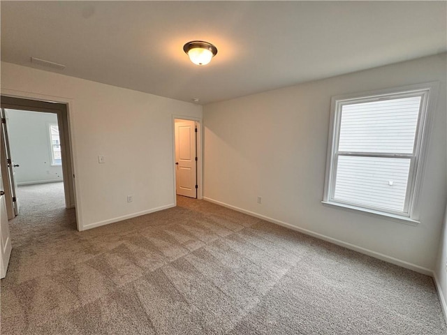 unfurnished bedroom featuring baseboards and carpet flooring