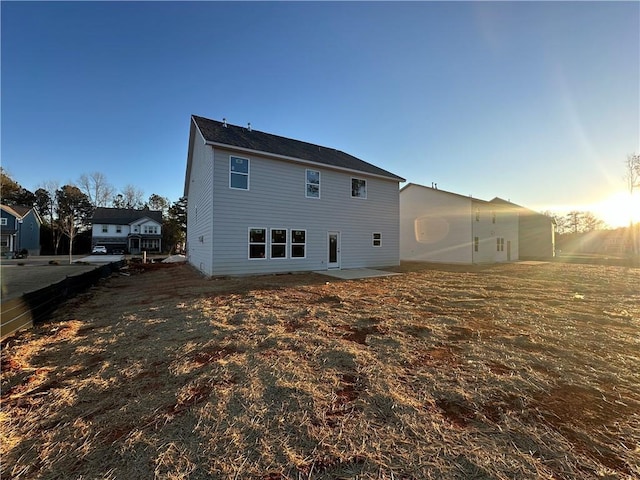 view of back house at dusk