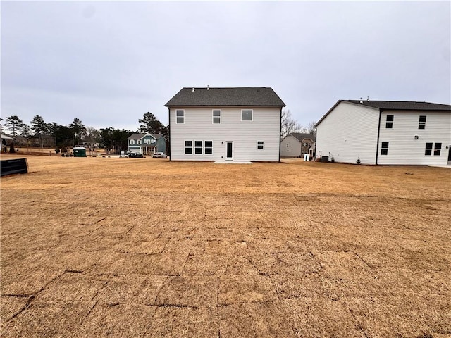 rear view of property featuring a yard