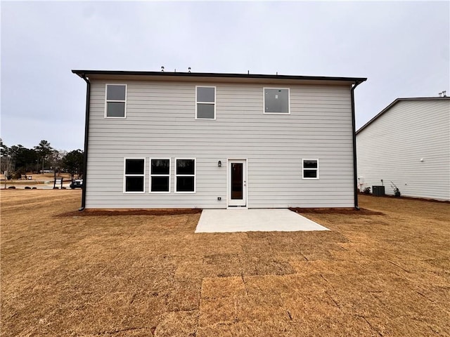 back of house with a patio area, a yard, and central air condition unit