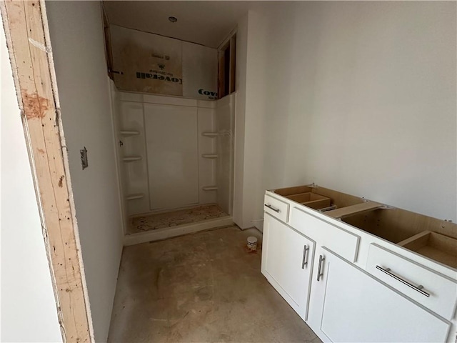 bathroom featuring concrete flooring and a shower