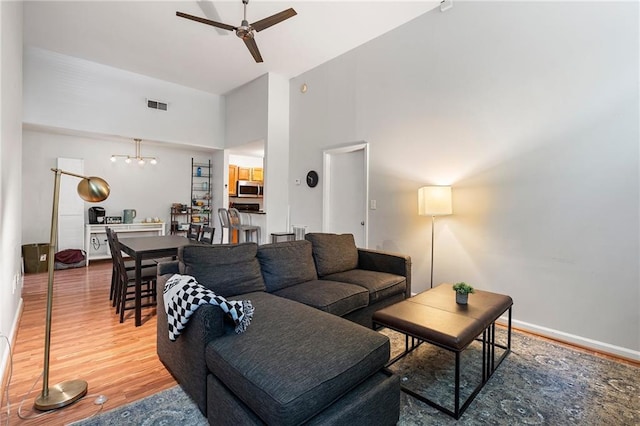 1031 State St NW Unit 106, Atlanta, GA 30318 - living room with a ceiling fan, a towering ceiling, and wood finished floors