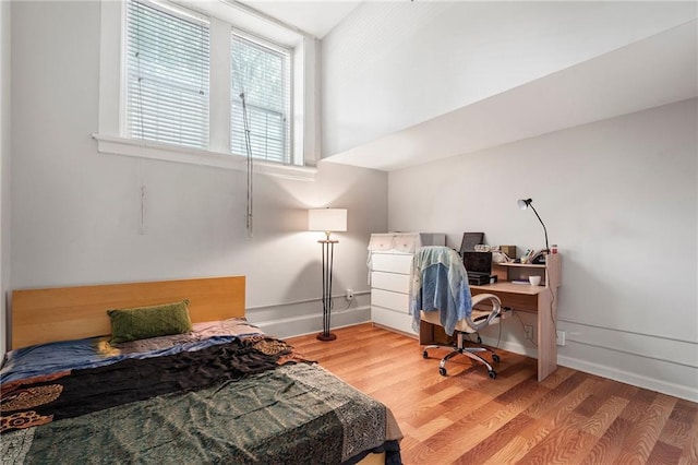 1031 State St NW Unit 106, Atlanta, GA 30318 - bedroom featuring light wood-style flooring, a desk, and baseboards