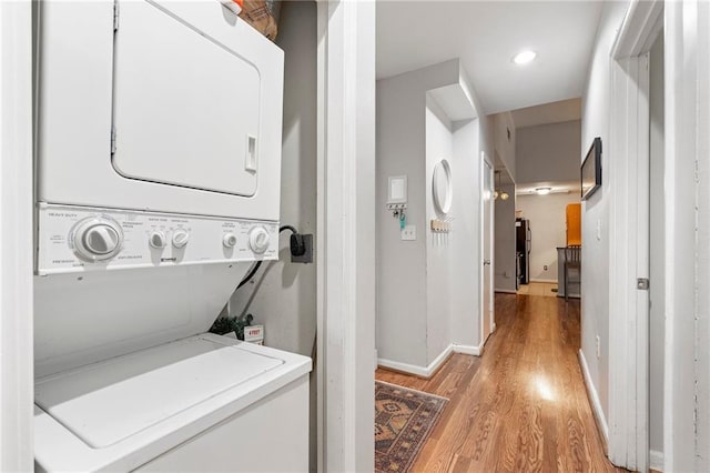 1031 State St NW Unit 106, Atlanta, GA 30318 - washroom with stacked washer / dryer, light wood-style floors, baseboards, and recessed lighting
