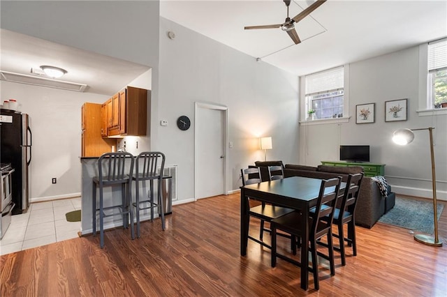 1031 State St NW Unit 106, Atlanta, GA 30318 - dining room featuring a ceiling fan, light wood-type flooring, and baseboards