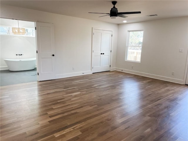 interior space featuring ceiling fan and dark hardwood / wood-style flooring