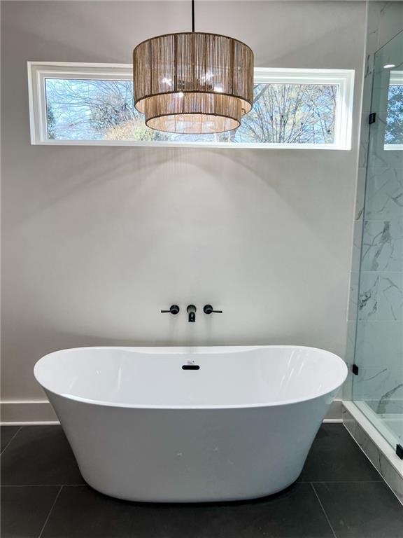 bathroom featuring tile patterned floors and plus walk in shower