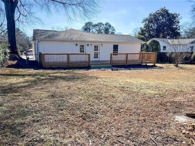 back of house featuring a yard and a deck