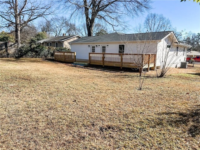 rear view of property with a wooden deck, a yard, and central air condition unit