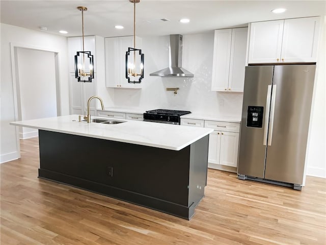 kitchen featuring white cabinetry, wall chimney range hood, and stainless steel refrigerator with ice dispenser