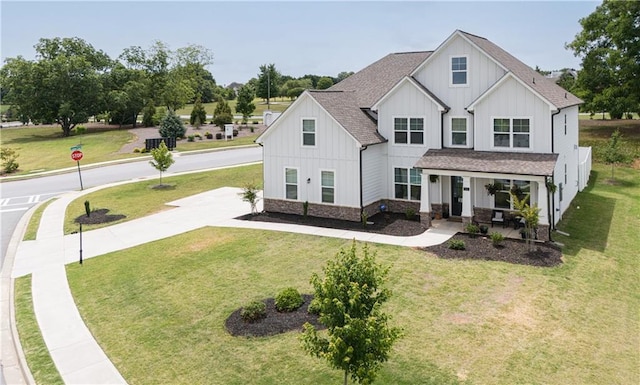 modern farmhouse style home with a front yard