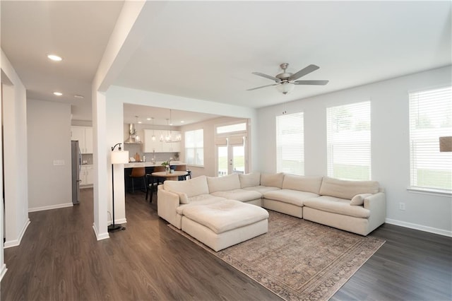 living room with ceiling fan and dark wood-type flooring