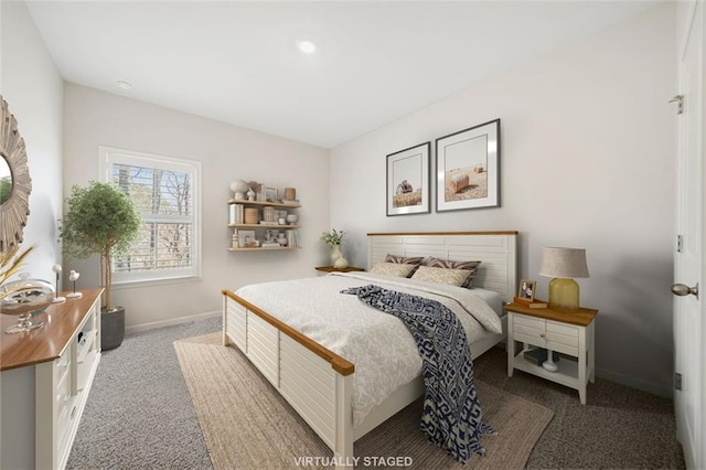 bedroom featuring carpet and baseboards