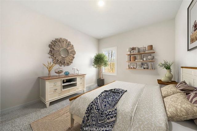 bedroom with carpet flooring and baseboards