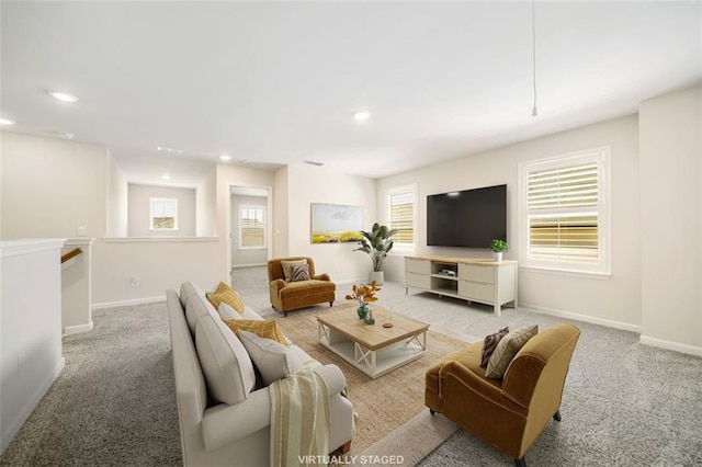 carpeted living area featuring recessed lighting and baseboards