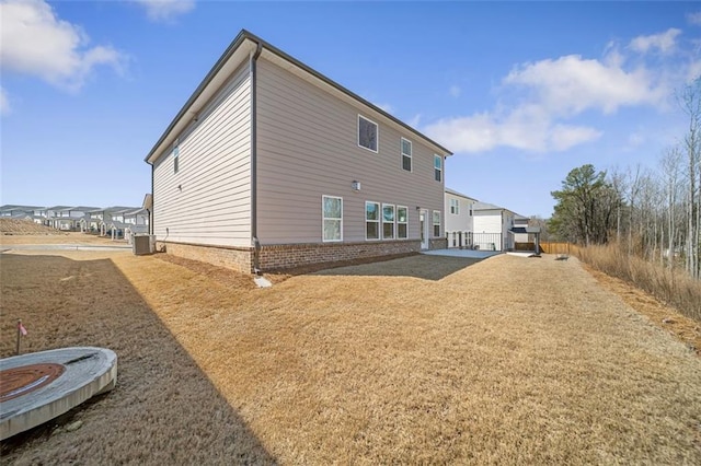 back of house featuring a patio and brick siding