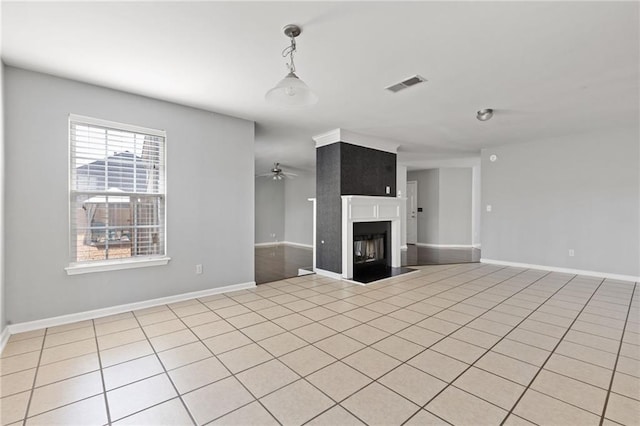 unfurnished living room featuring a fireplace, light tile patterned floors, visible vents, a ceiling fan, and baseboards