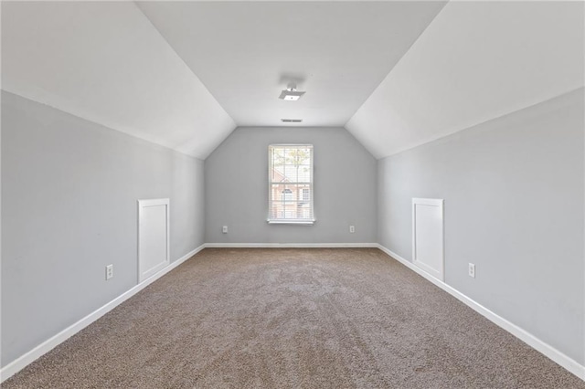 bonus room with carpet, visible vents, lofted ceiling, and baseboards