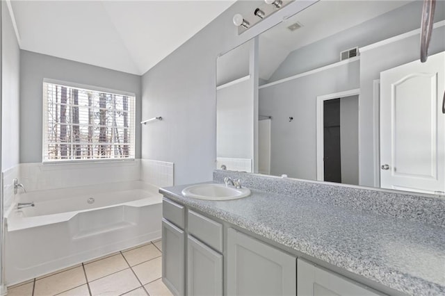 bathroom with lofted ceiling, tile patterned flooring, vanity, visible vents, and a bath