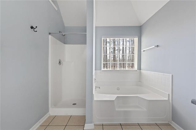 bathroom with a garden tub, baseboards, vaulted ceiling, a shower, and tile patterned floors