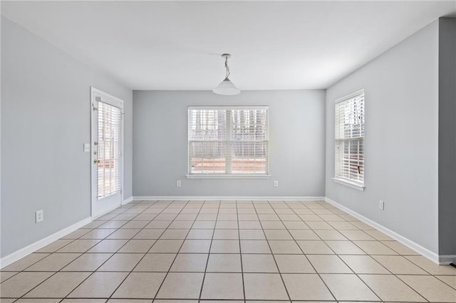 spare room with baseboards