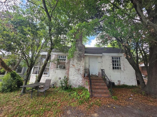 1435 Troupe St, Augusta, GA 30904 - view of front of house featuring brick siding, cooling unit, and a chimney