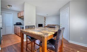 586 Windchase Ln, Stone Mountain, GA 30083 - dining room featuring baseboards, wood finished floors, and a fireplace